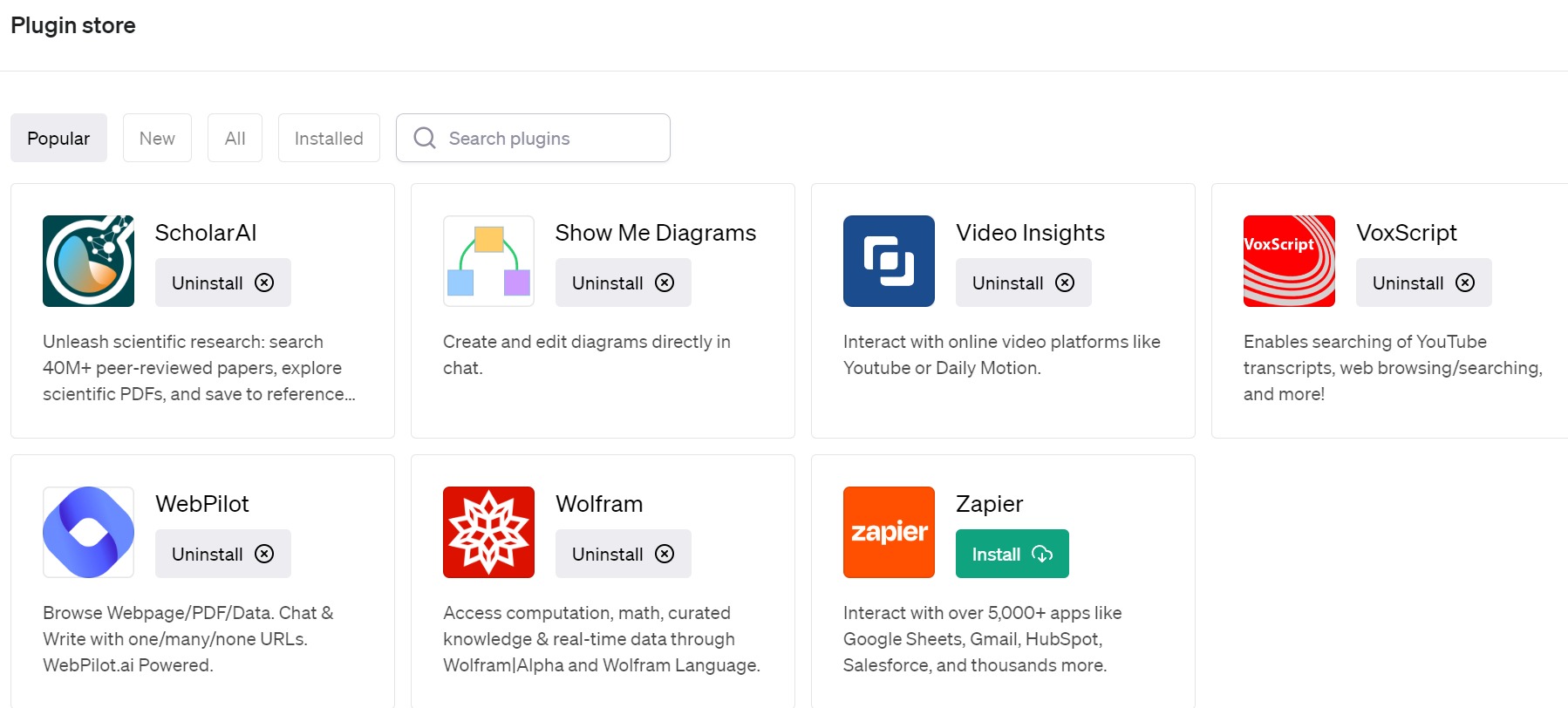 A screenshot of the ChatGPT-4 plugin store window where users can search for and activate up to three plugins for any given conversation. Example plugins shown on this page of popular plugins include ScholarAI, Show Me Diagrams, Video Insights, VoxScript, WebPilot, Wolfram, and Zapier.